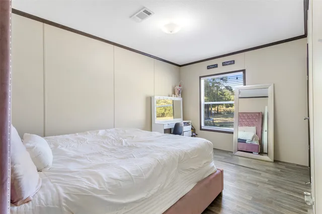 a bedroom with a large bed and a window