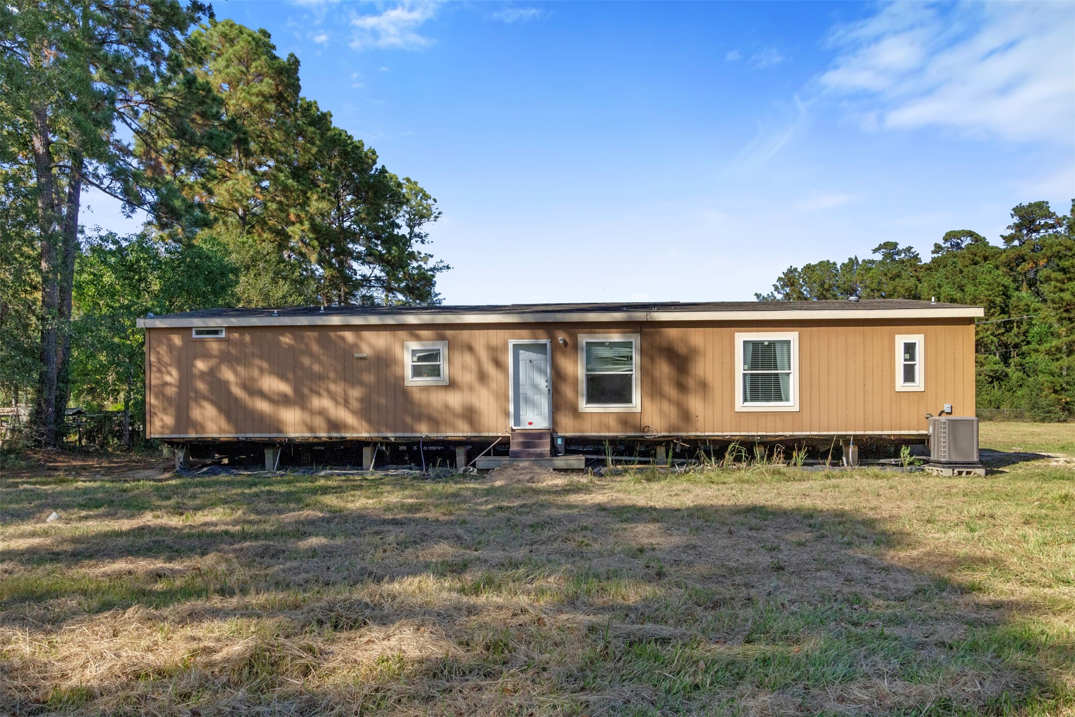 27182 East River Road Splendora, TX 77372 - Photo 17 of 40 a view of a house with a yard