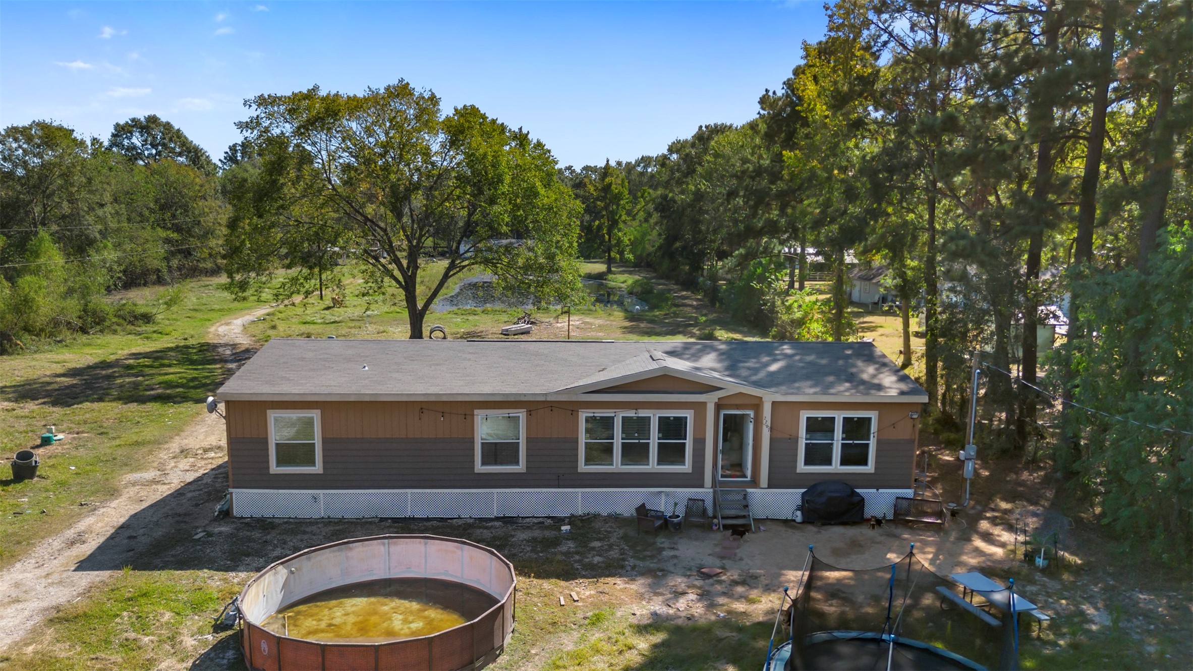 27182 East River Road Splendora, TX 77372 - Photo 2 of 40 a front view of a house with a yard