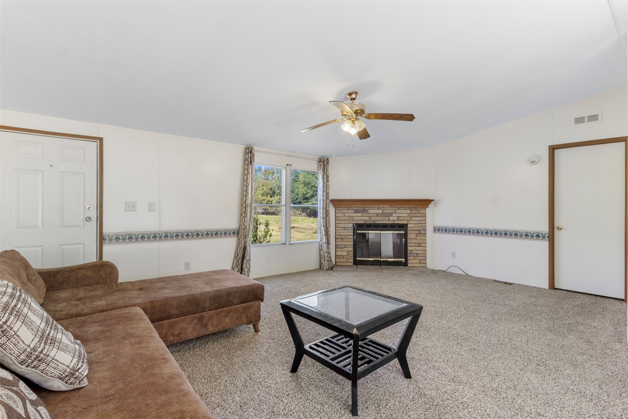 27182 East River Road Splendora, TX 77372 - Photo 20 of 40 a living room with furniture and a fireplace
