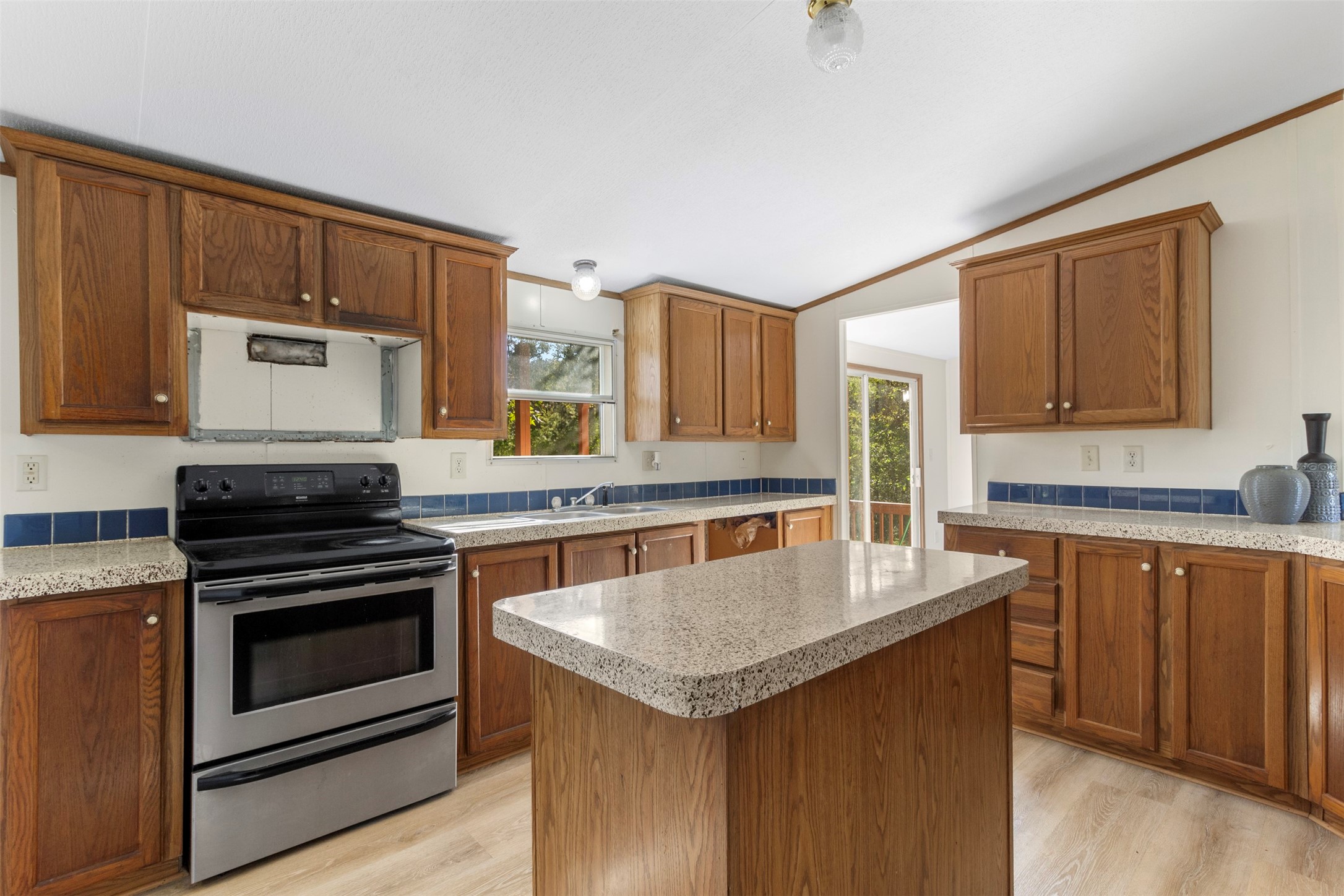 27182 East River Road Splendora, TX 77372 - Photo 24 of 40 a kitchen with granite countertop a stove and a sink