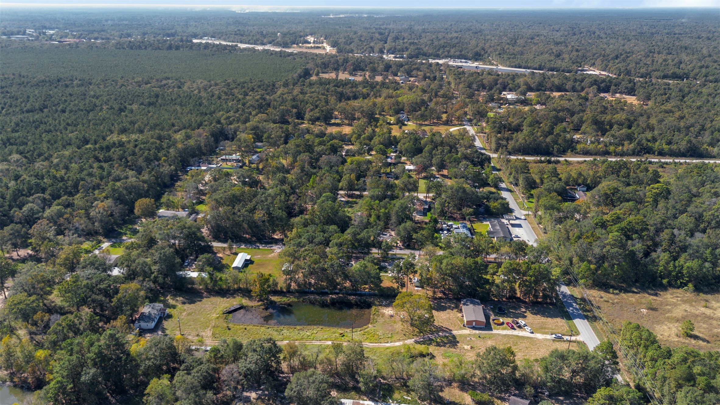 27182 East River Road Splendora, TX 77372 - Photo 3 of 40 an aerial view of residential houses with outdoor space and trees