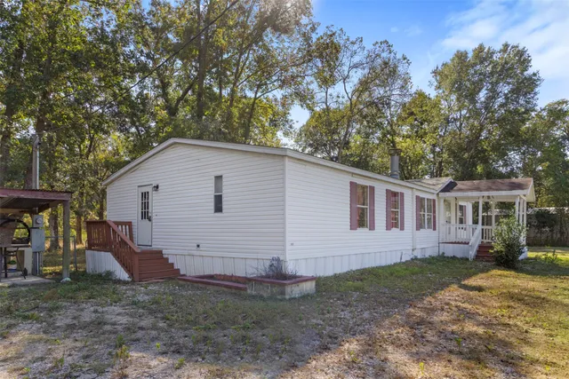 a view of a house with wooden deck