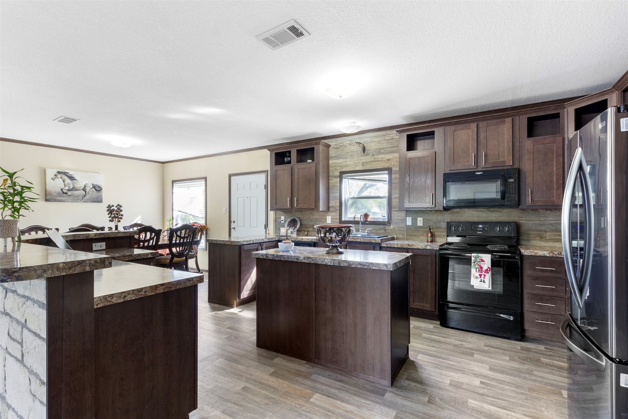 27182 East River Road Splendora, TX 77372 - Photo 5 of 40 a kitchen with stainless steel appliances granite countertop sink stove top oven and refrigerator