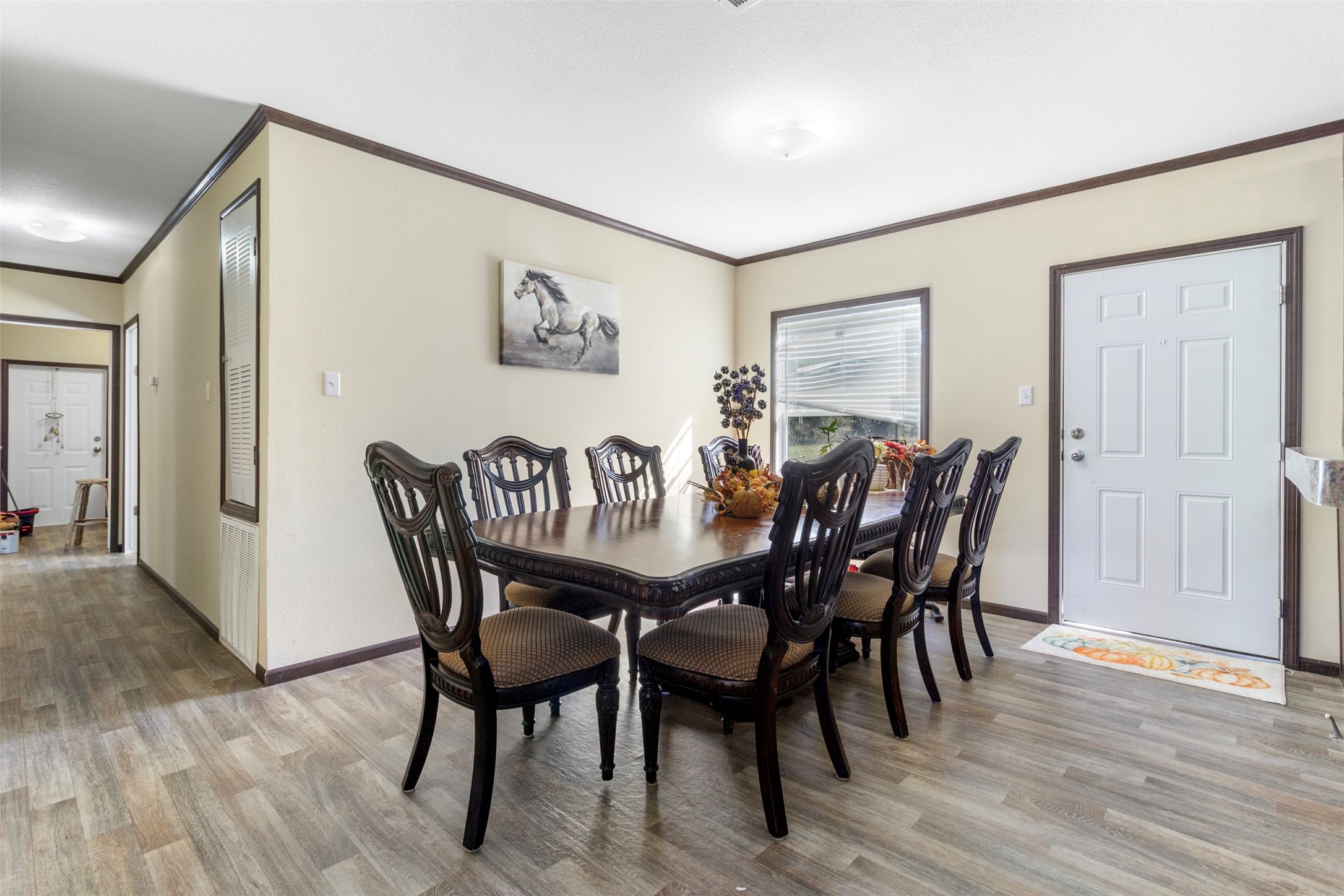27182 East River Road Splendora, TX 77372 - Photo 9 of 40 a view of a dining room with furniture and wooden floor