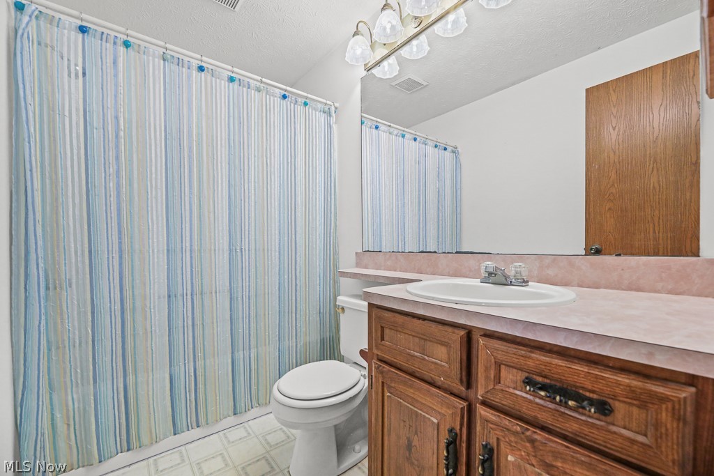 2642 Blake Road Wadsworth, OH 44281 - Photo 21 of 46 Bathroom featuring a wood-finish vanity with an integrated sink and laminate countertop