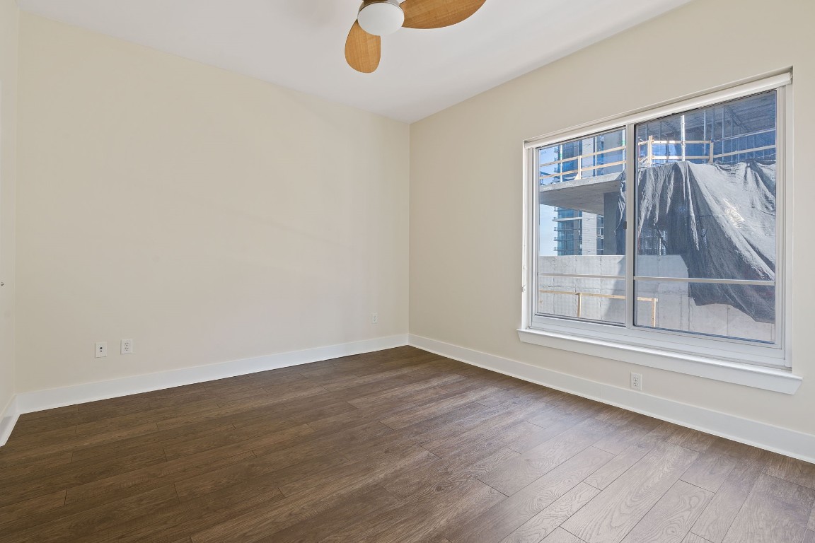 603 Davis Street, Unit 1304 Austin, TX 78701 - Photo 16 of 40 a view of an empty room with a window and wooden floor