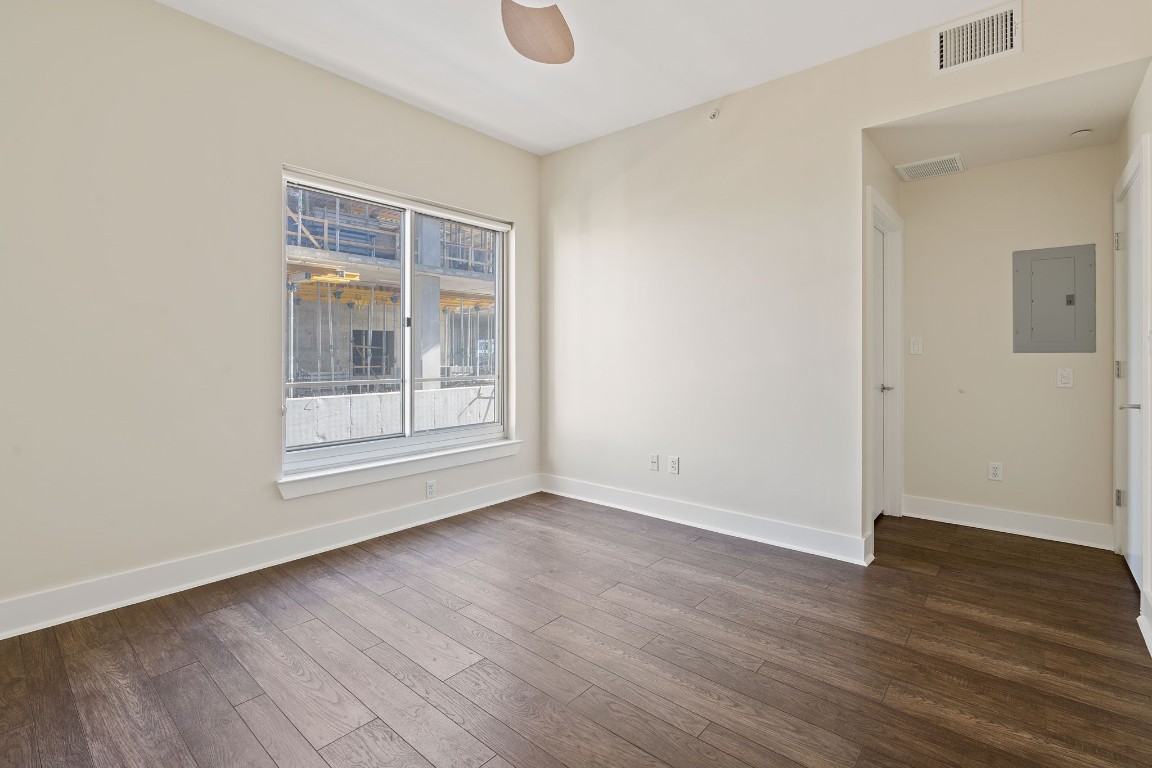 603 Davis Street, Unit 1304 Austin, TX 78701 - Photo 18 of 40 a view of an empty room with wooden floor and a window