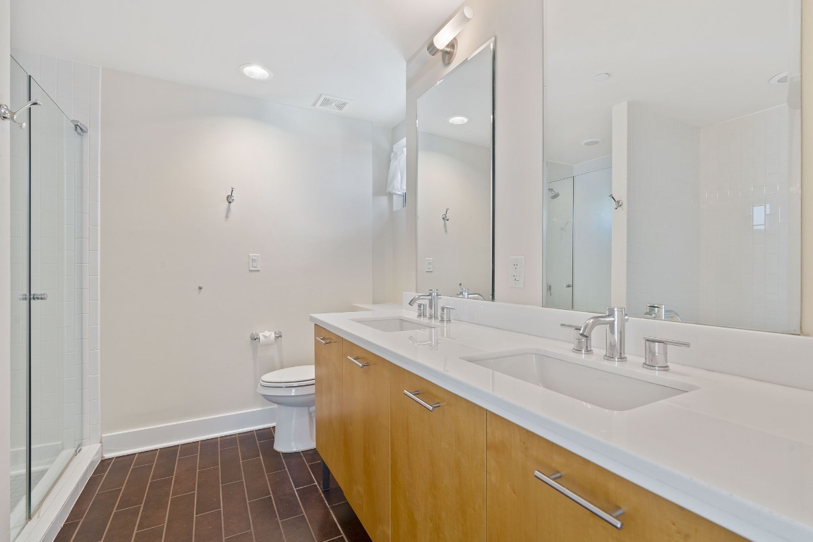 603 Davis Street, Unit 1304 Austin, TX 78701 - Photo 19 of 40 a bathroom with a sink toilet and shower