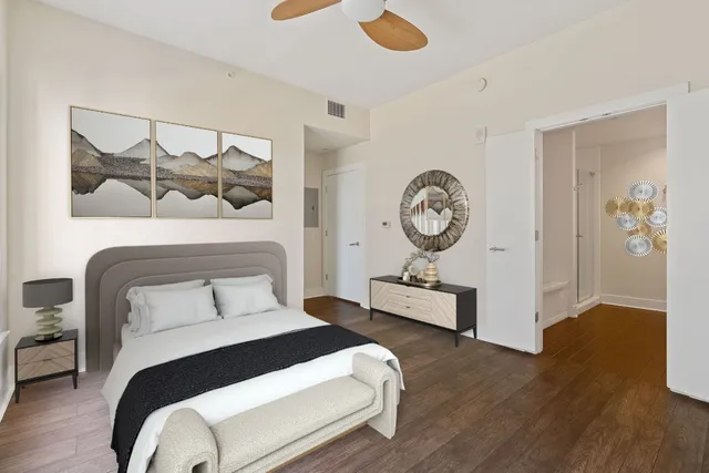 a bedroom with a bed and wooden floor