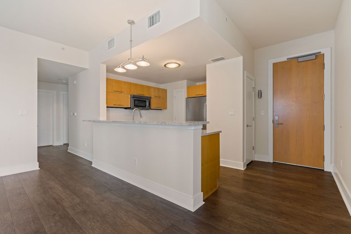 603 Davis Street, Unit 1304 Austin, TX 78701 - Photo 7 of 40 a view of a kitchen with wooden floor and a sink