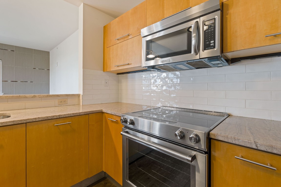 603 Davis Street, Unit 1304 Austin, TX 78701 - Photo 8 of 40 a kitchen with a stove microwave and sink