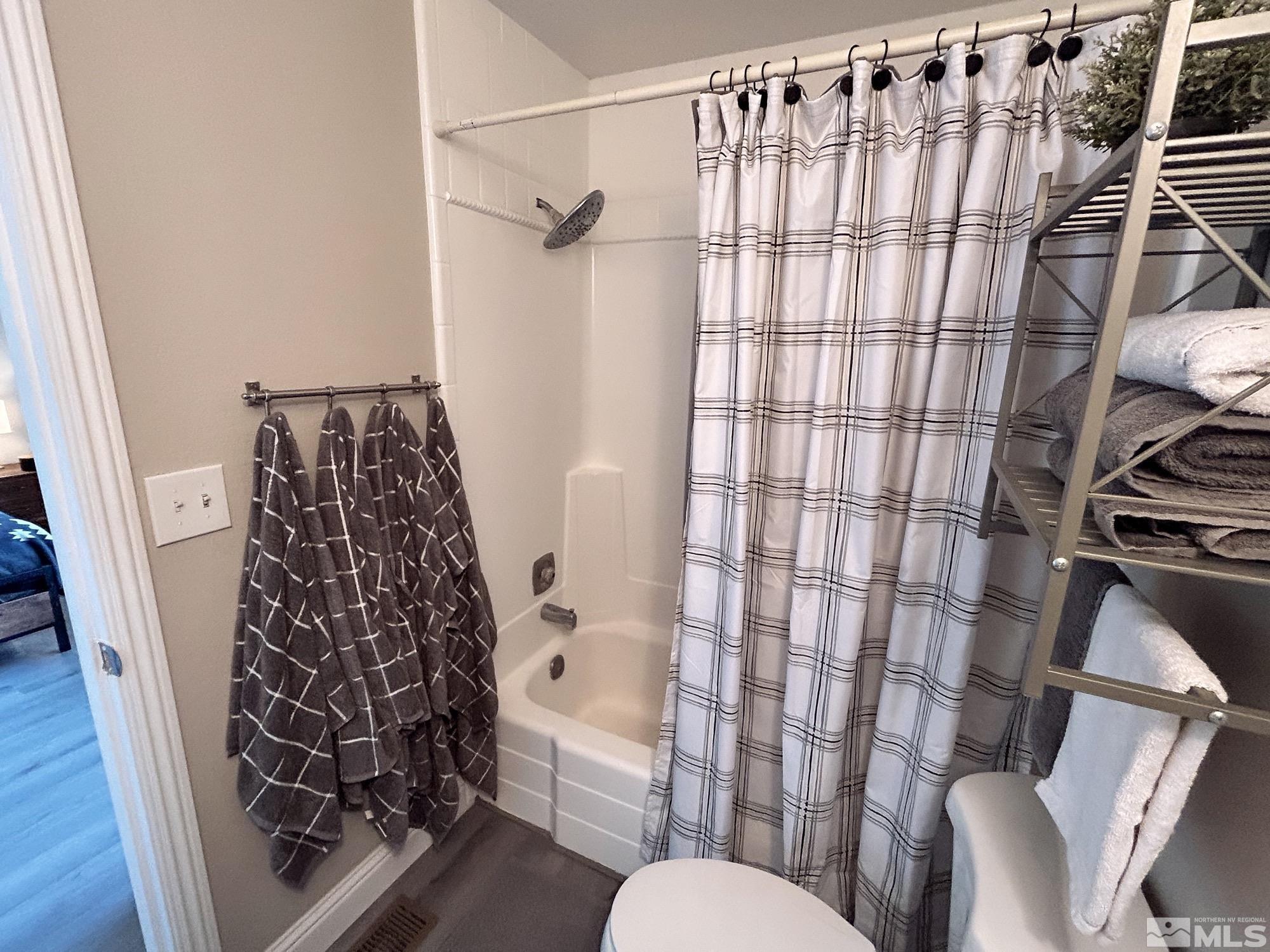 130 Ring Road Dayton, NV 89403 - Photo 18 of 21 a bathroom with a toilet and shower curtain