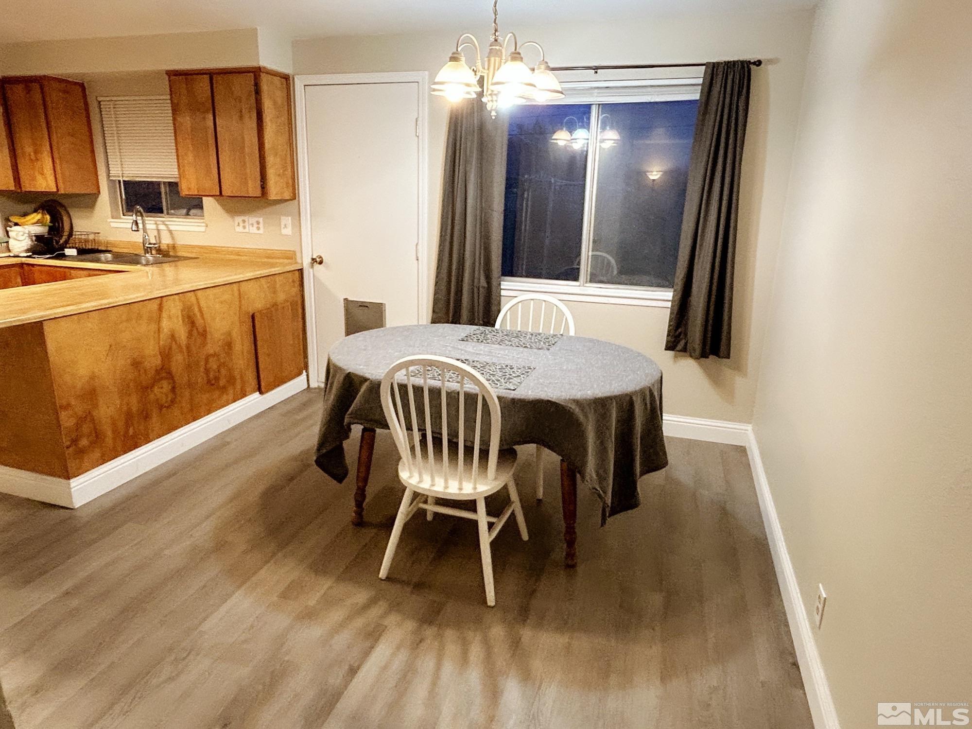 130 Ring Road Dayton, NV 89403 - Photo 2 of 21 a view of a dining room with furniture and wooden floor