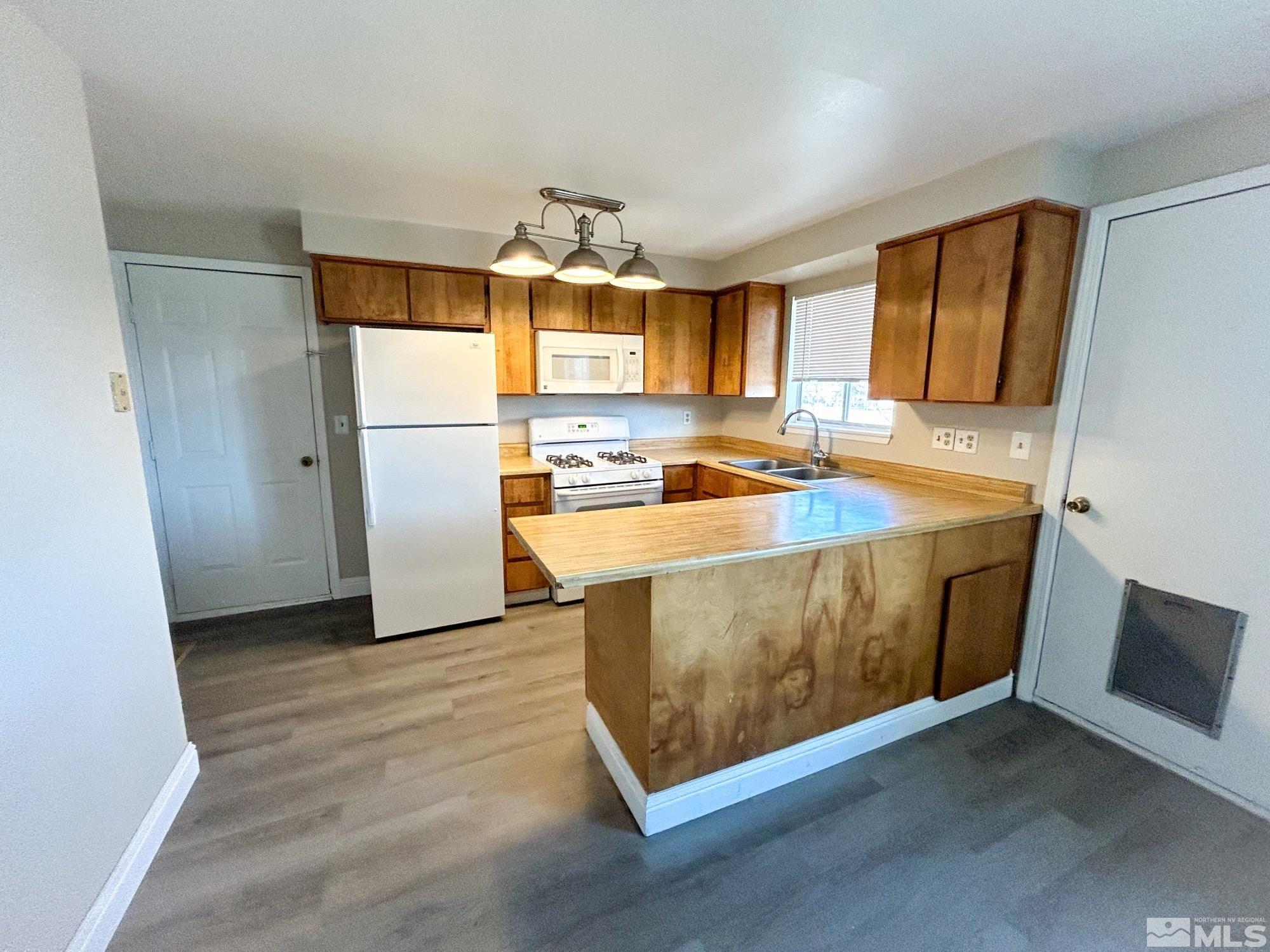 130 Ring Road Dayton, NV 89403 - Photo 4 of 21 a kitchen with a sink stove and refrigerator