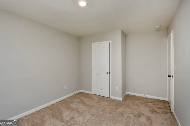 a bathroom with a bathtub shower sink vanity mirror and toilet