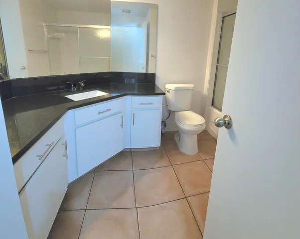 a bathroom with a shower and a toilet
