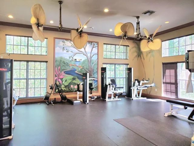 a room with pool table and windows