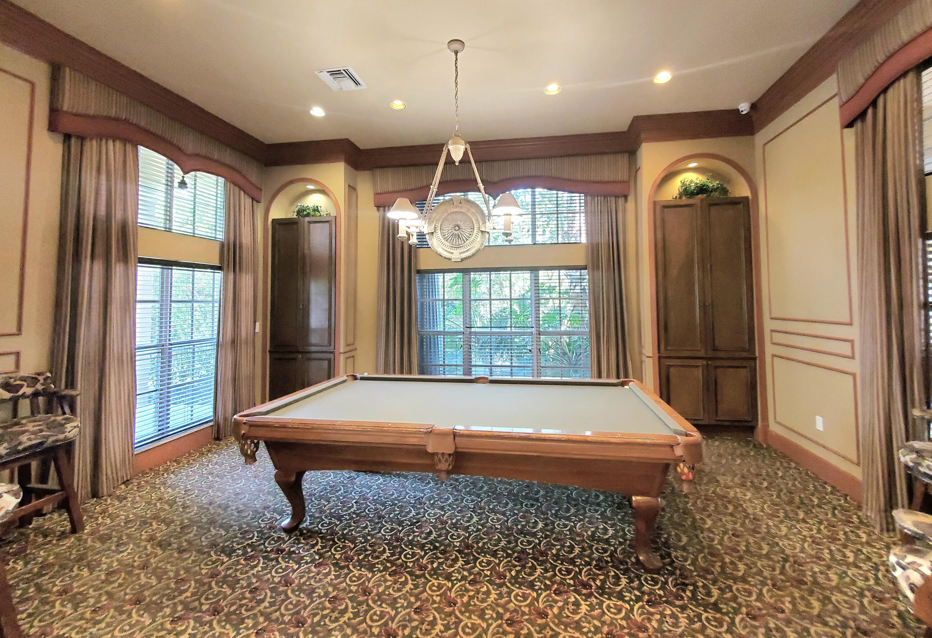 1000 Scotia Drive, Unit 106 Hypoluxo, FL 33462 - Photo 24 of 28 a room with pool table and windows