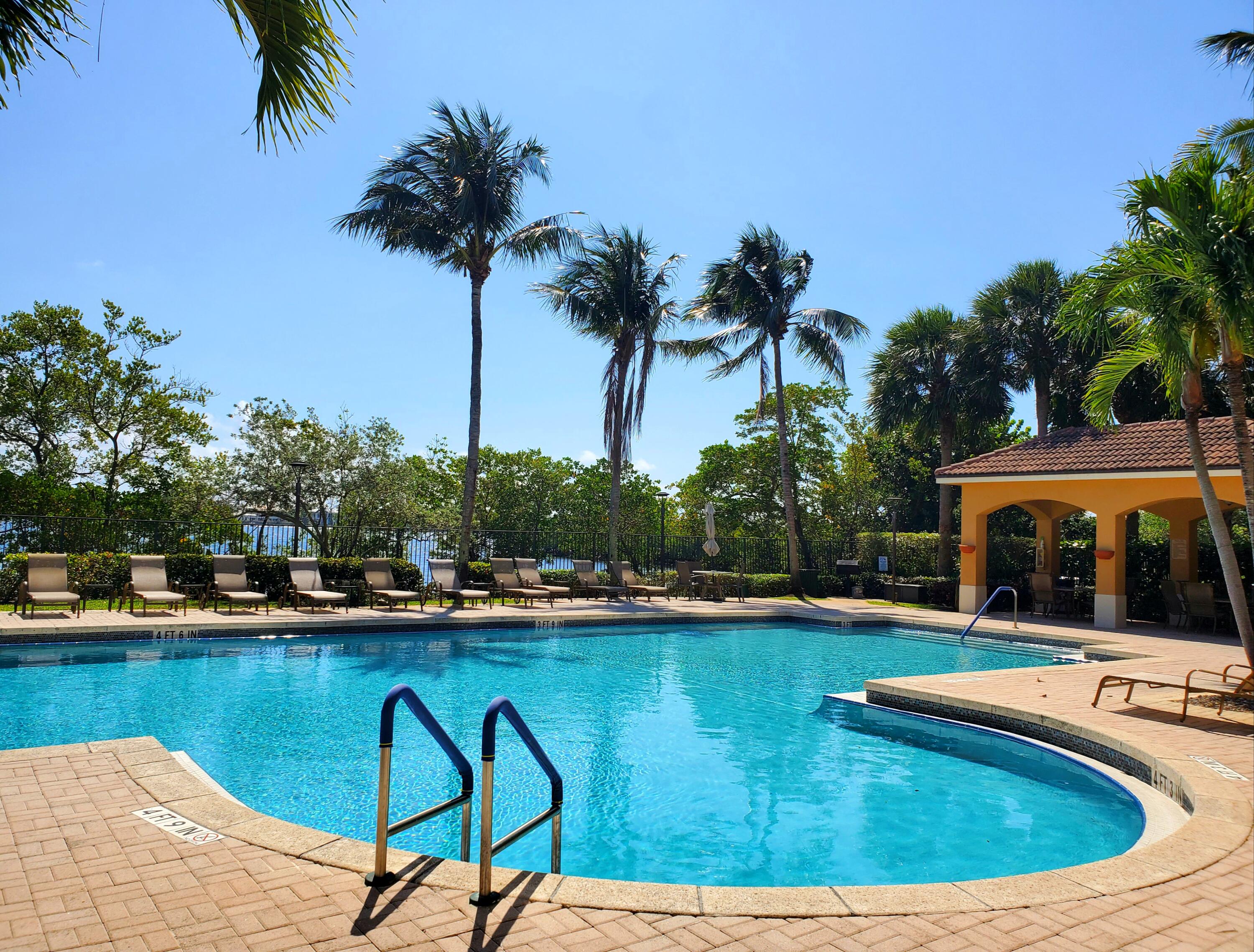 1000 Scotia Drive, Unit 106 Hypoluxo, FL 33462 - Photo 28 of 28 a view of swimming pool with chairs