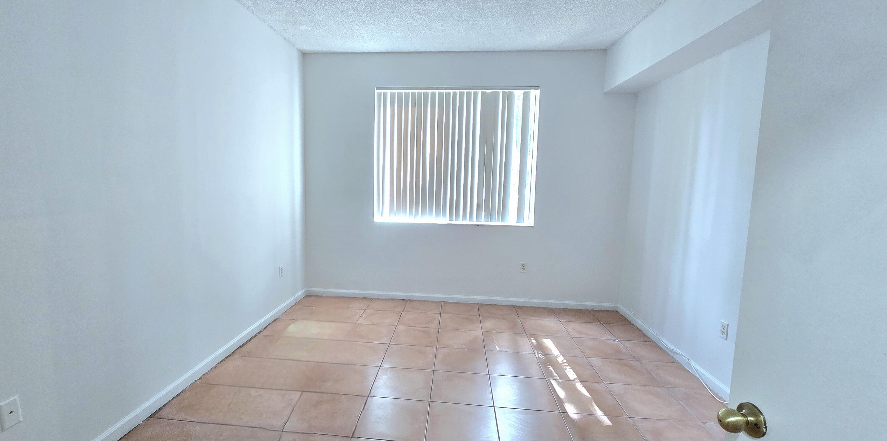 1000 Scotia Drive, Unit 106 Hypoluxo, FL 33462 - Photo 10 of 28 a view of an empty room with a window