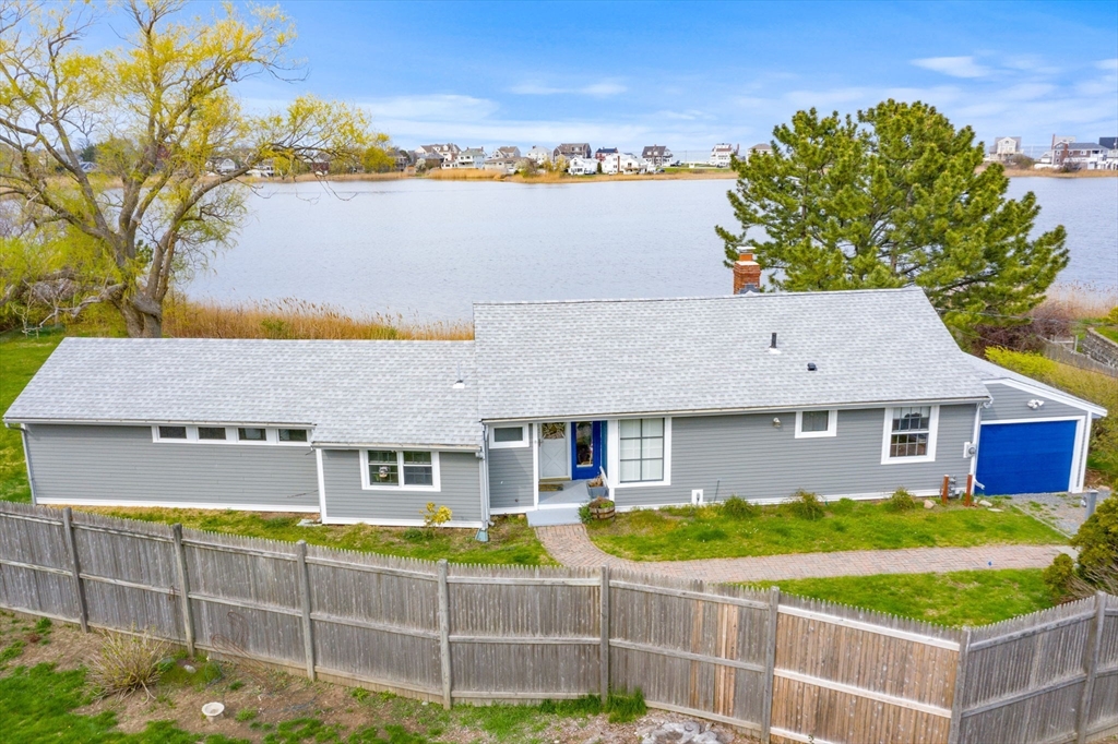 a view of a house with backyard and swimming pool