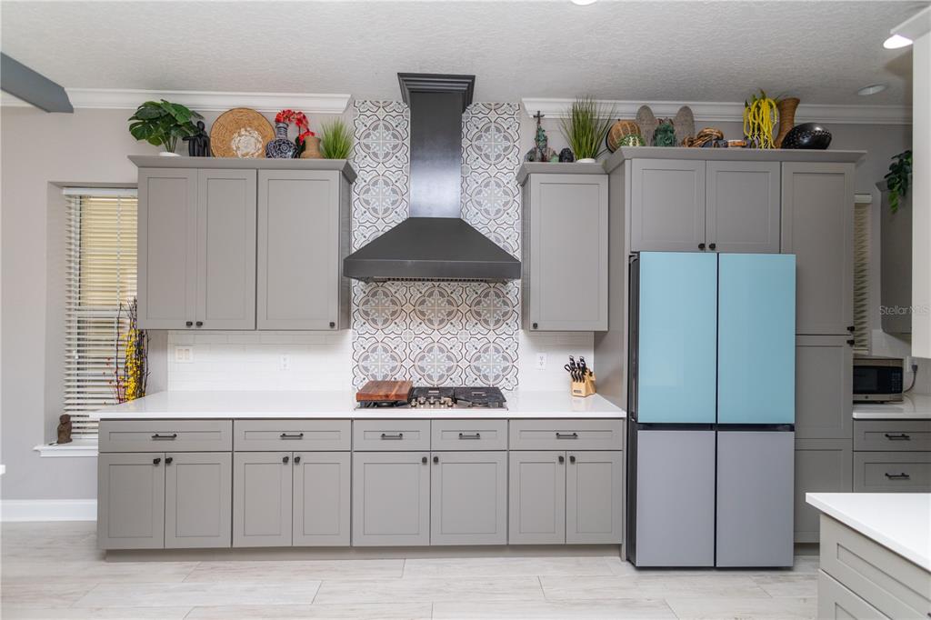 3305 Schoolhouse Road St. Cloud, FL 34773 - Photo 8 of 83 a kitchen with stainless steel appliances granite countertop a refrigerator and a stove