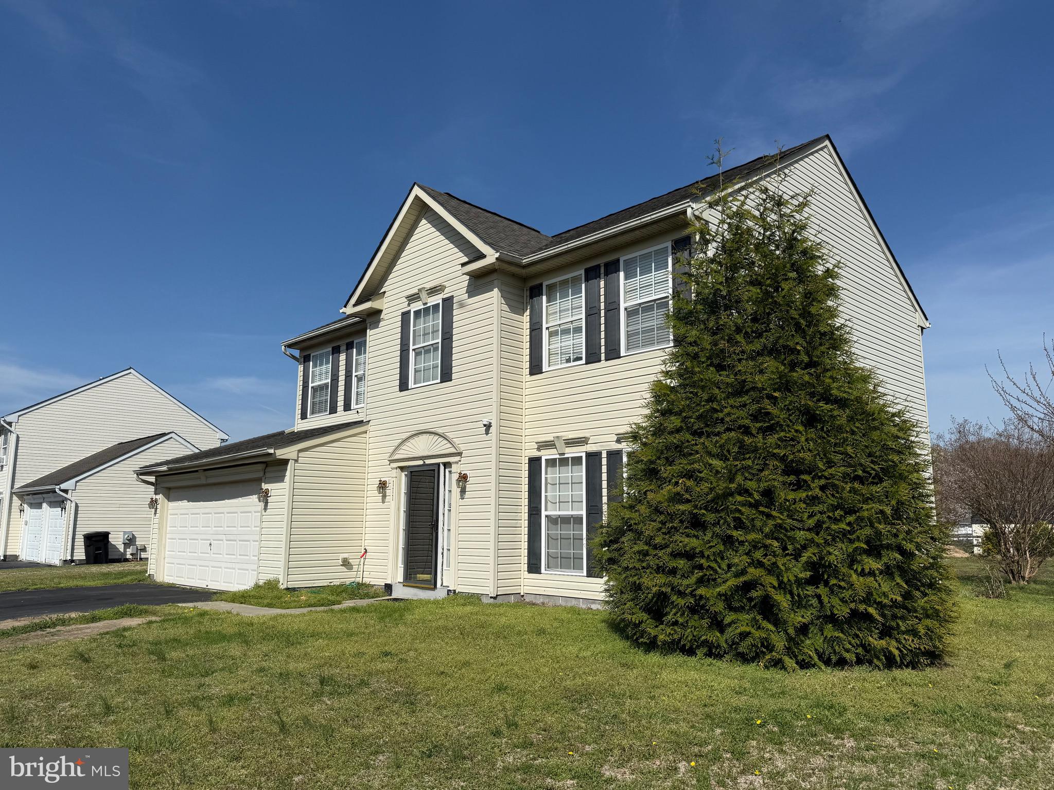 111 Martin Drive Hurlock, MD 21643 - Photo 3 of 27 a front view of a house with a garden