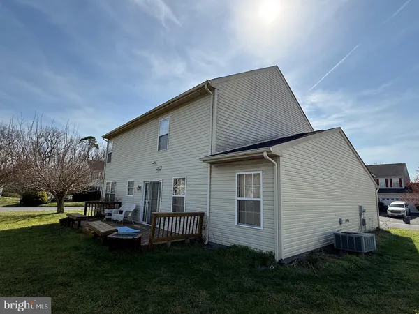a backyard of a house with table and chairs
