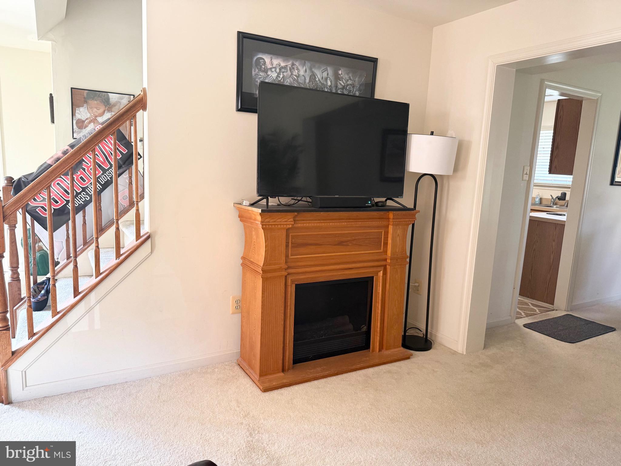 111 Martin Drive Hurlock, MD 21643 - Photo 9 of 27 a living room with a fireplace and a flat screen tv