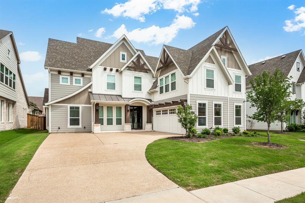 a front view of a house with a yard and trees