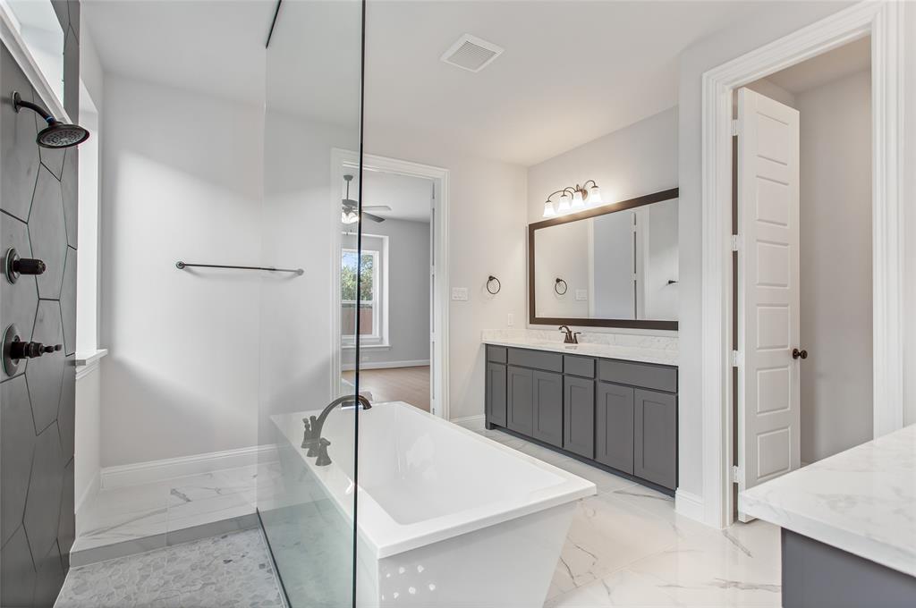 805 Veranda View McKinney, TX 75069 - Photo 20 of 40 a spacious bathroom with a granite countertop sink mirror and shower