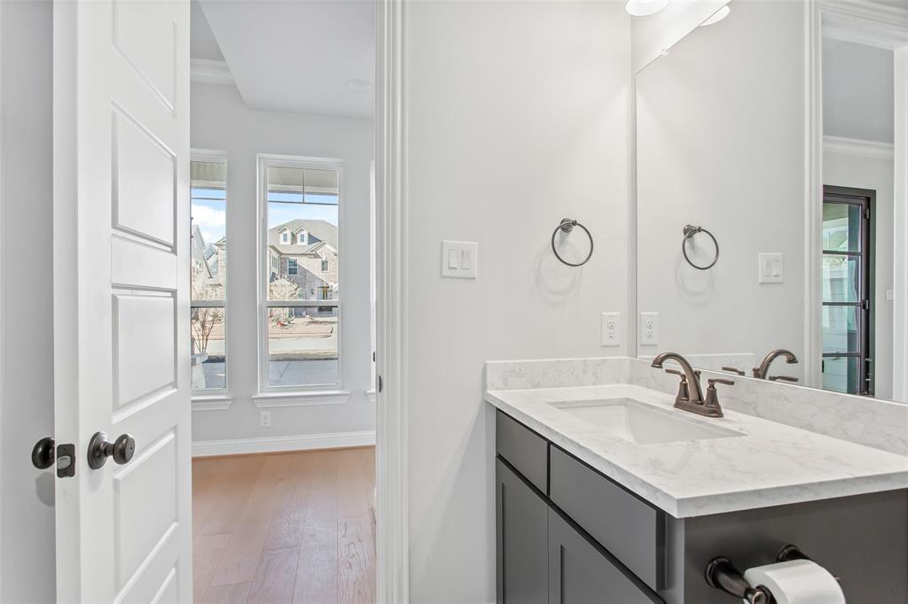 805 Veranda View McKinney, TX 75069 - Photo 23 of 40 a bathroom with a sink vanity and a mirror