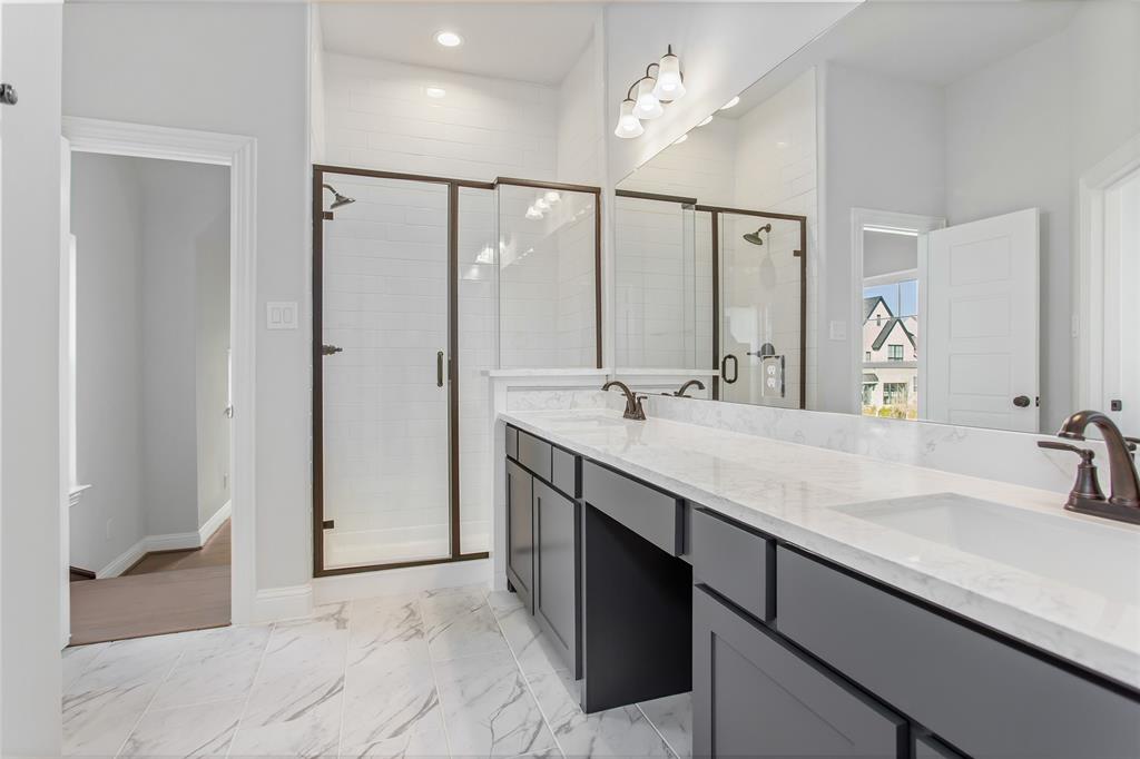 805 Veranda View McKinney, TX 75069 - Photo 31 of 40 a bathroom with a double vanity sink a mirror and shower