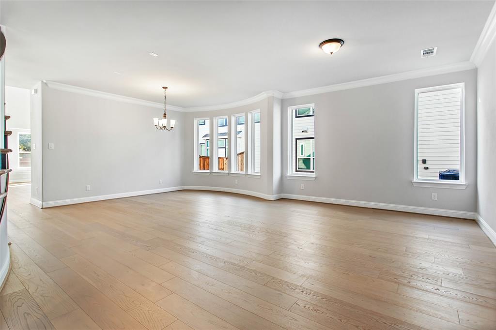 805 Veranda View McKinney, TX 75069 - Photo 9 of 40 an empty room with wooden floor and windows