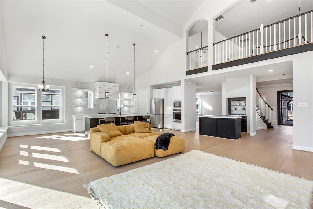 805 Veranda View McKinney, TX 75069 - Photo 10 of 40 a living room with furniture kitchen view and a chandelier