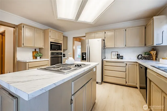 a kitchen with kitchen island a stove a sink dishwasher and refrigerator