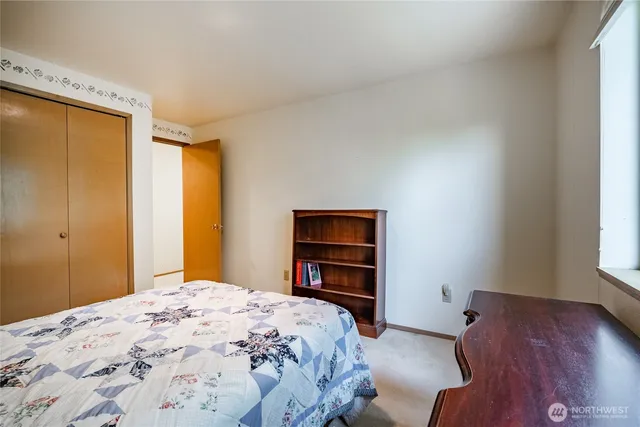 a bedroom with a bed and a dresser