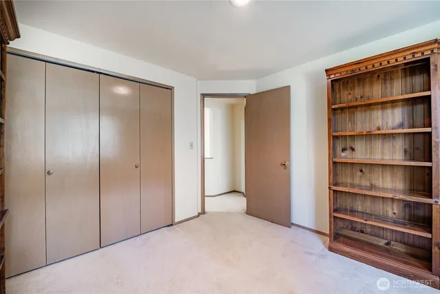 a view of an empty room with empty shelves