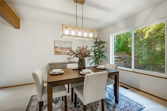a dining room with furniture a window and a chandelier