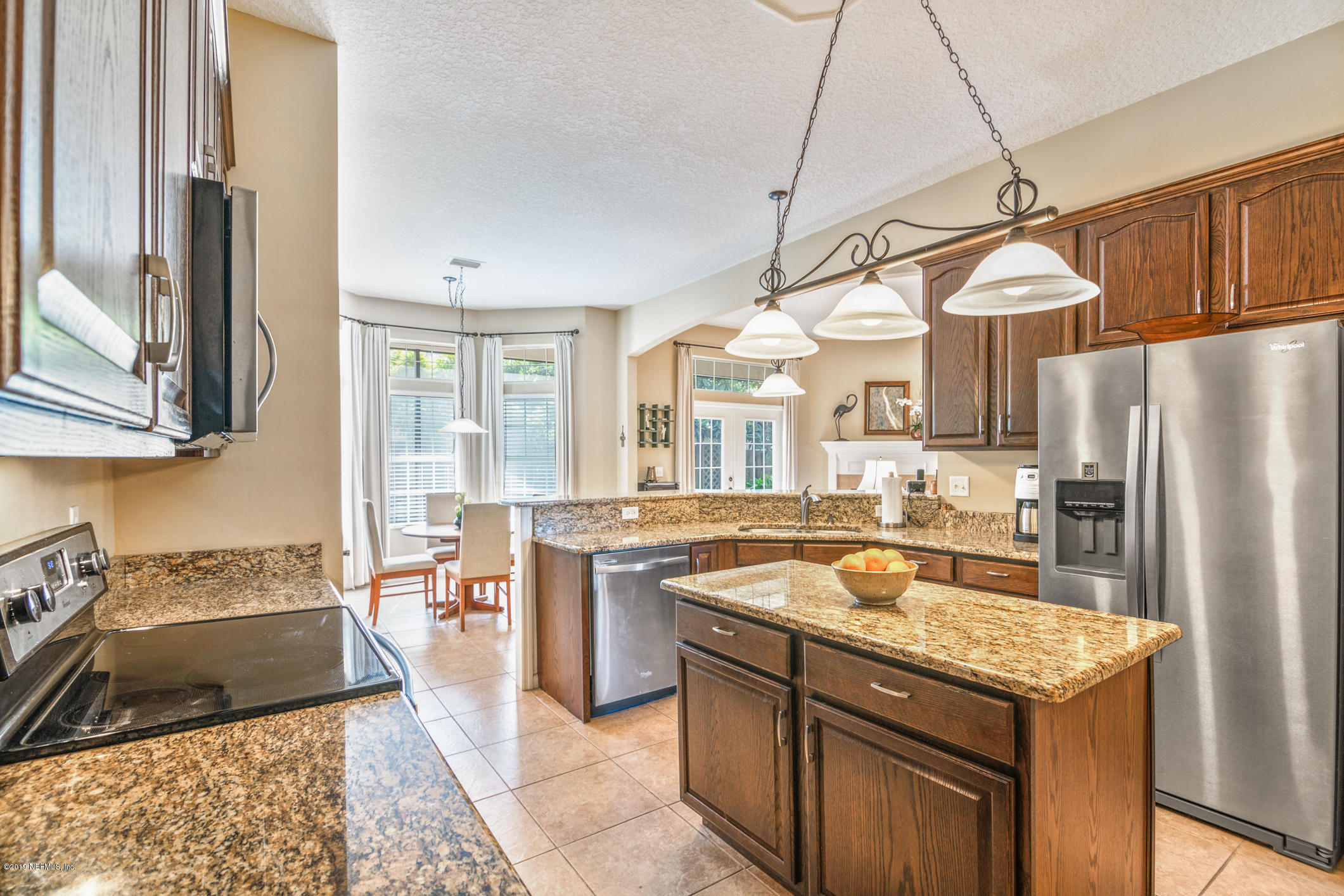 330 Orchis Road St. Augustine, FL 32086 - Photo 11 of 24 a kitchen with granite countertop cabinets and refrigerator