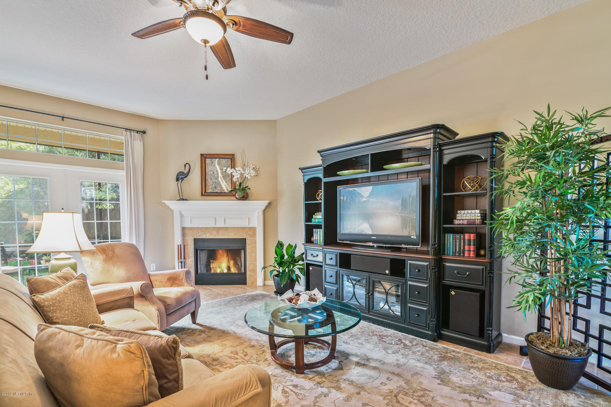 330 Orchis Road St. Augustine, FL 32086 - Photo 6 of 24 a living room with furniture a flat screen tv and a fireplace