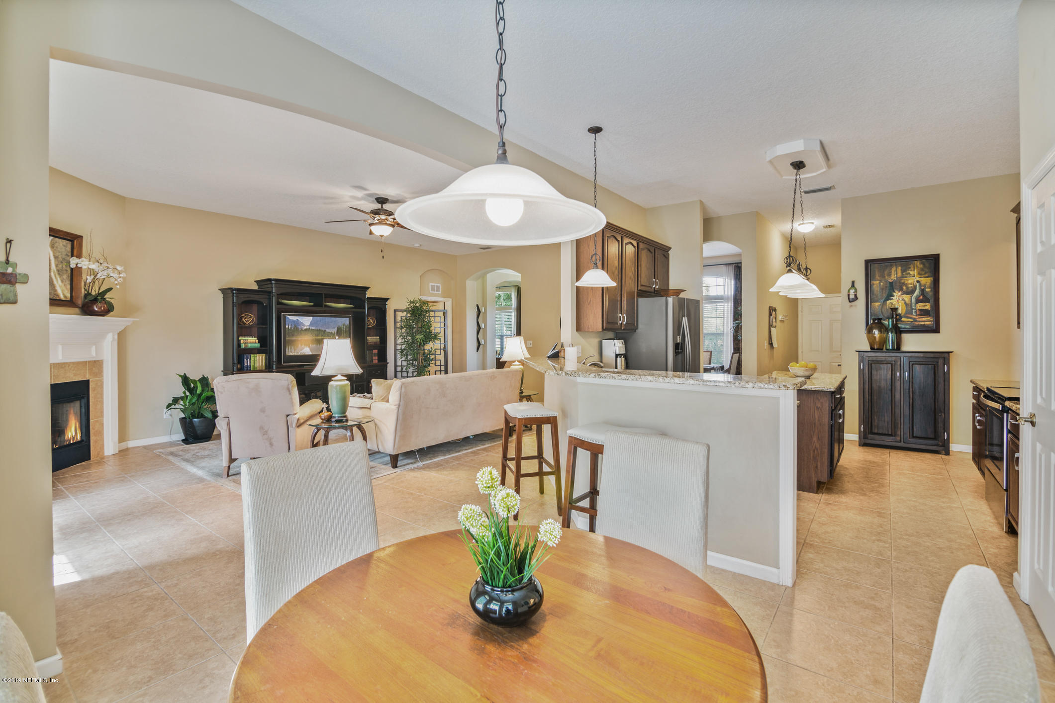 330 Orchis Road St. Augustine, FL 32086 - Photo 8 of 24 a view of a dining room and kitchen with furniture a chandelier