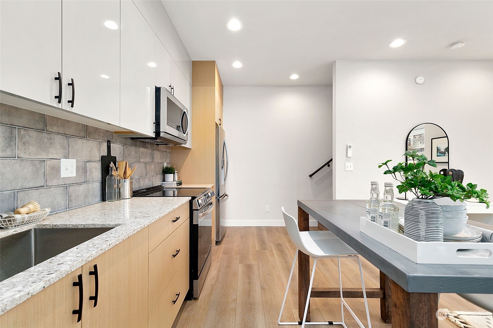1609 South Washington Street Seattle, WA 98144 - Photo 6 of 14 a kitchen with stainless steel appliances kitchen island granite countertop a sink a stove and cabinets