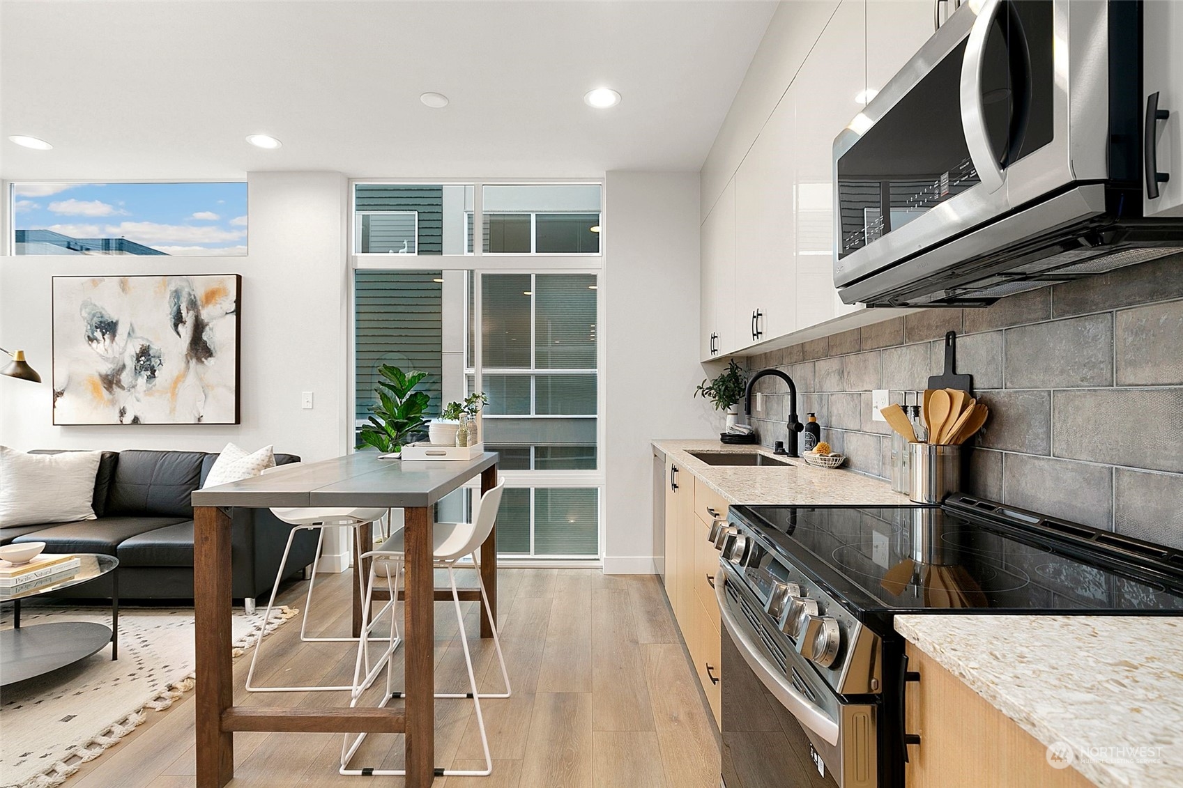 1609 South Washington Street Seattle, WA 98144 - Photo 7 of 14 a kitchen with stainless steel appliances granite countertop a stove a sink a microwave and a refrigerator