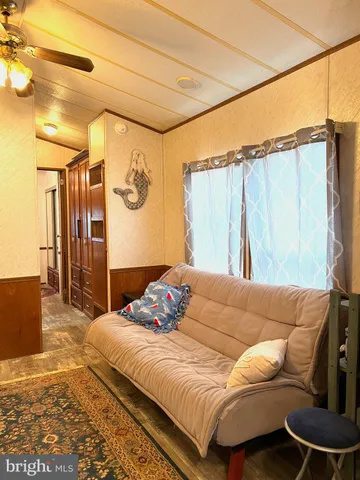 a dining room filled chandelier and wooden furniture