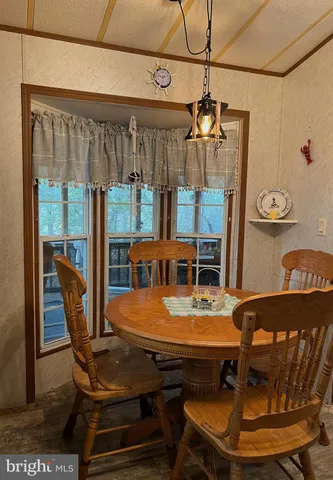 a bedroom with a bed a dresser and windows