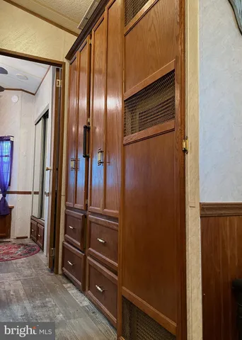 a bedroom with a bed a dresser and window