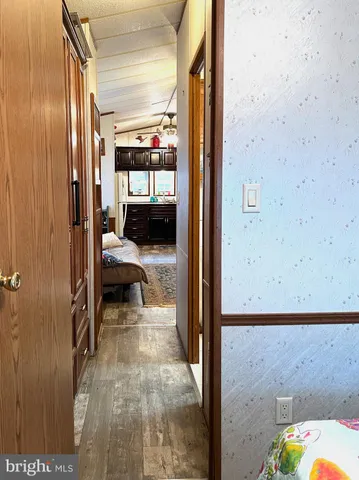 a bedroom with a bed and a large mirror