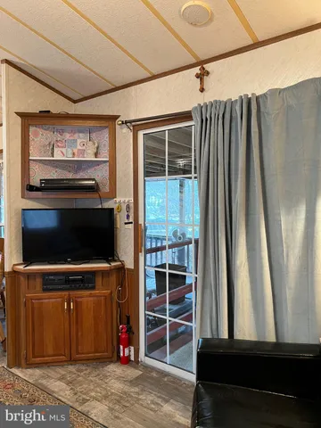 a dining room with furniture window and wooden floor